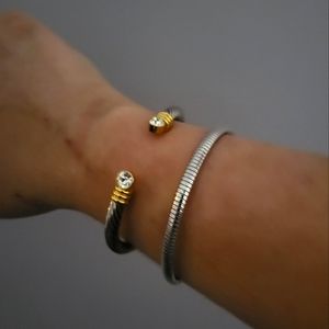 Never worn bracelets, silver in color with a hint of gold, OS from Joan Rivers